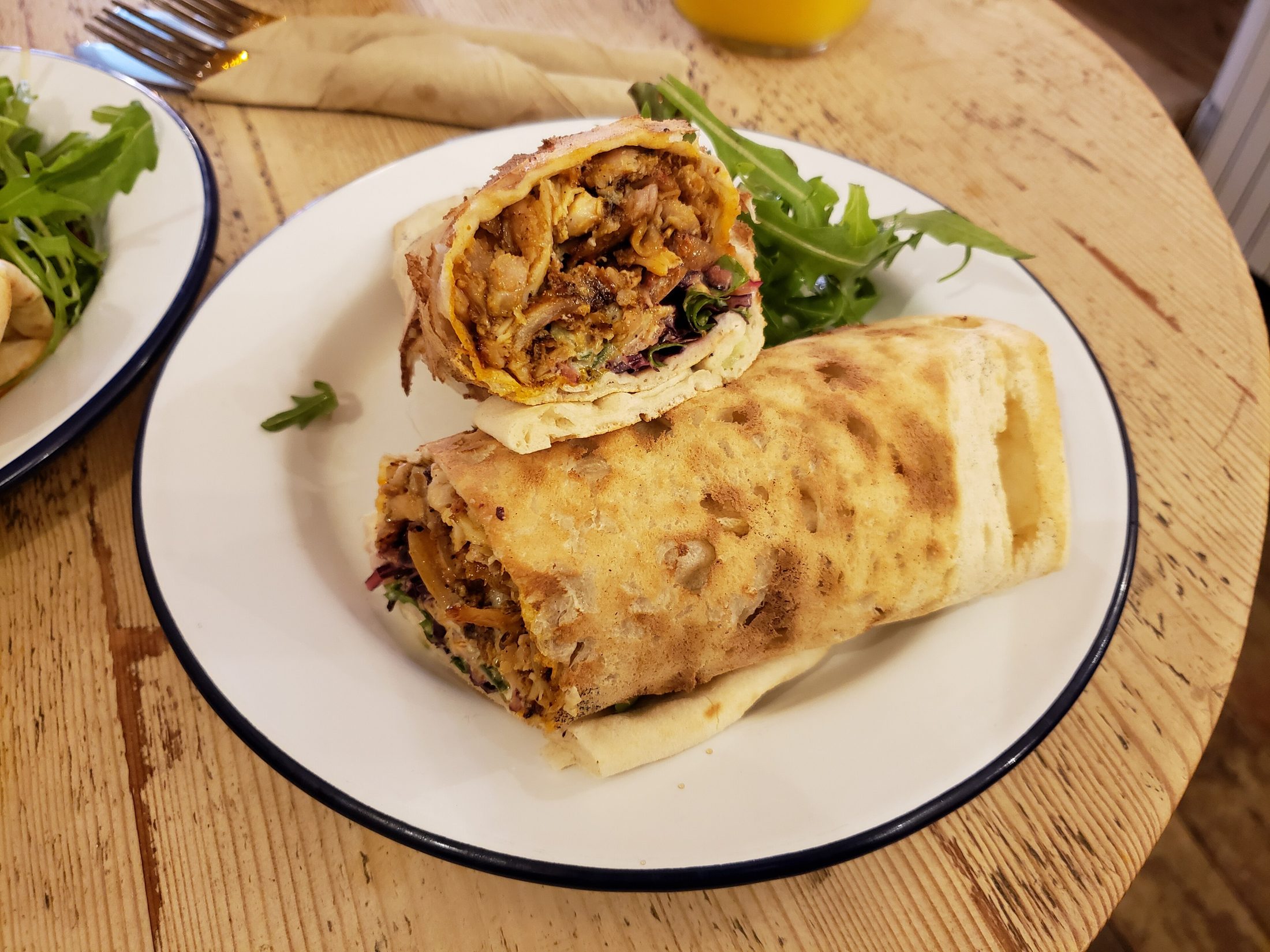 Chicken Shawarma — Marinated for hours, seared golden, wrapped in warm bread with pickles and garlic sauce.