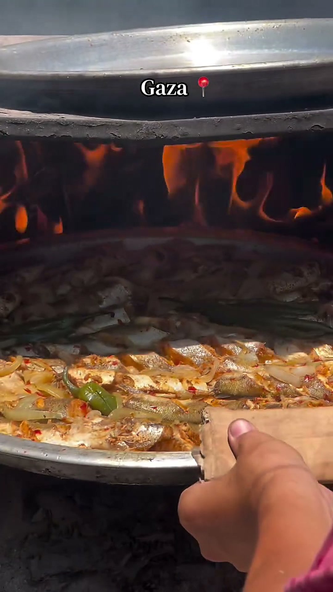 Oven-Baked Fish Tray — Whole fish marinated in garlic, lemon and warm spices, roasted over onions, tomatoes and peppers.