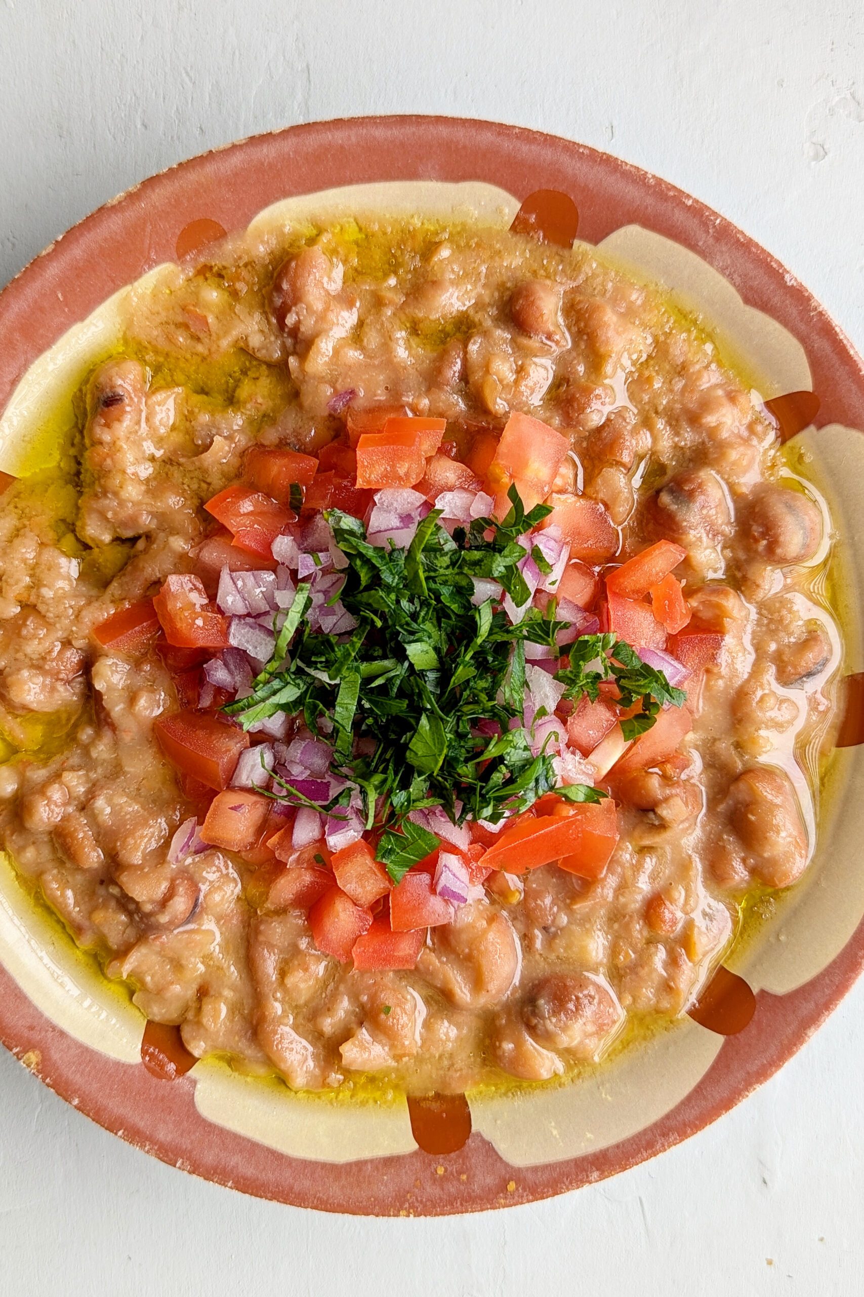 Traditional Gaza Ful — Gaza's mashed fava-bean breakfast — garlicky, lemony, drowned in good olive oil and shared from one plate.