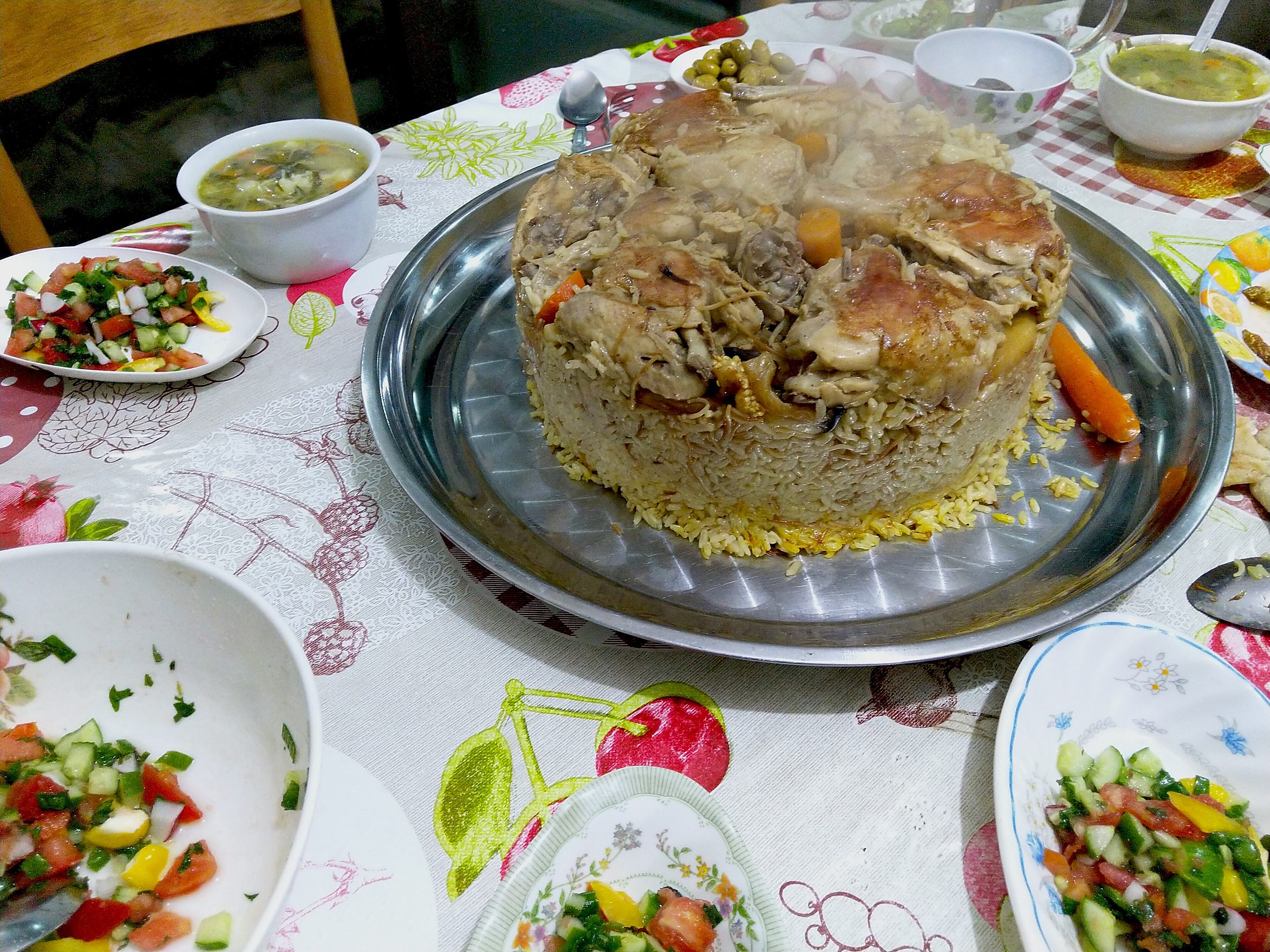 Maqluba — The famous upside-down pot of rice, chicken and fried vegetables — flipped whole at the table.